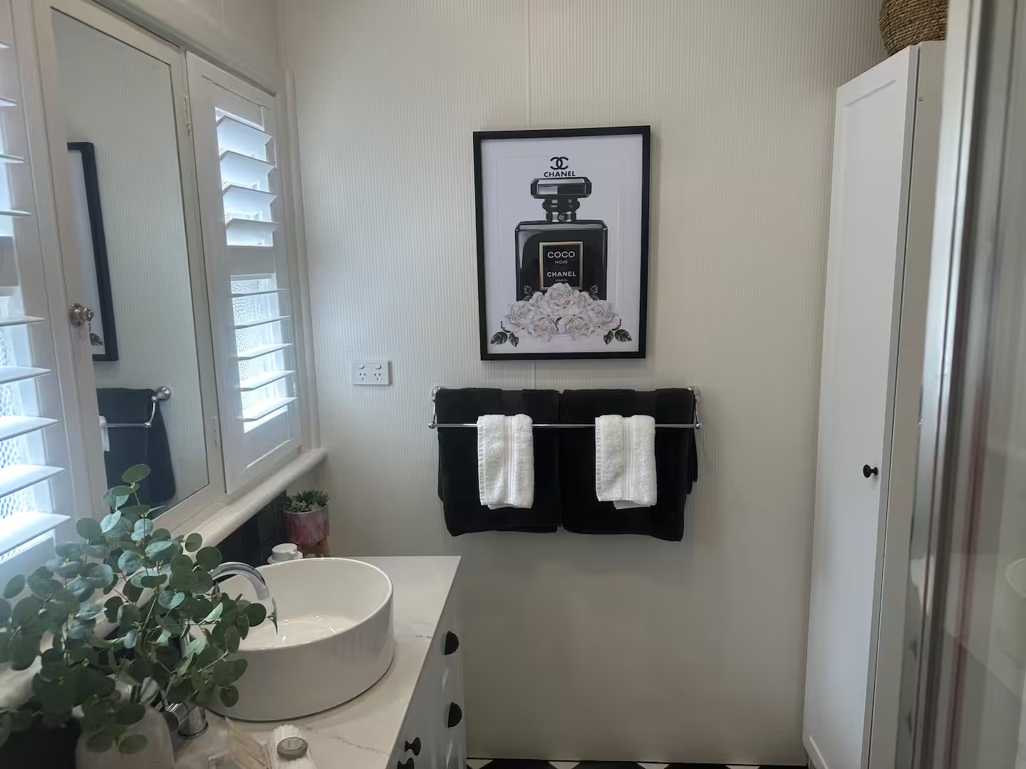 The rear deck features cosy furniture with soft, fluffy cushions and a stylish faux rug, creating a welcoming atmosphere.  An above-deck heater ensures warmth on cooler evenings, while solar lights illuminate the space at night.
