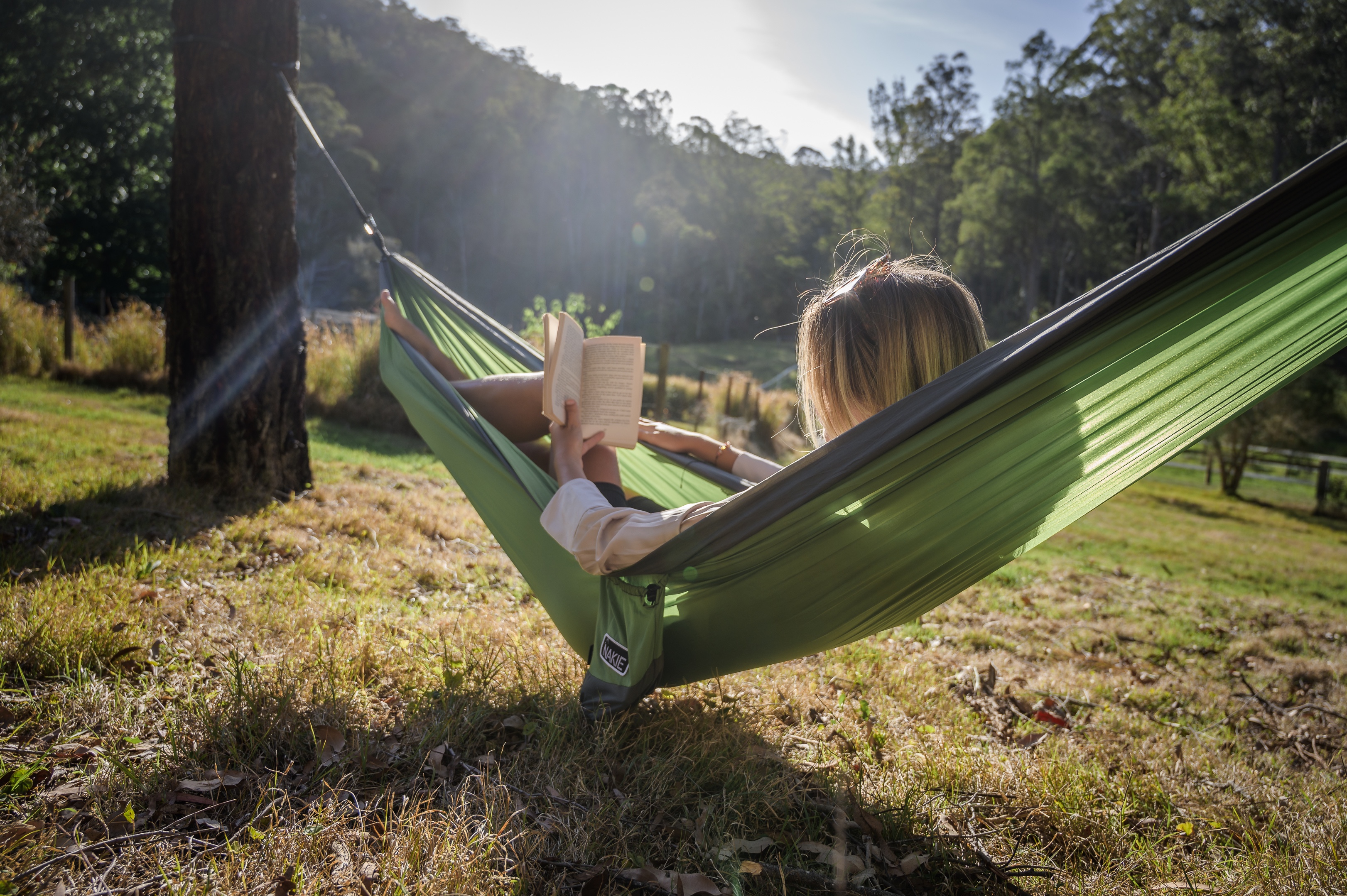 A young guest, reading a book in the hammock
