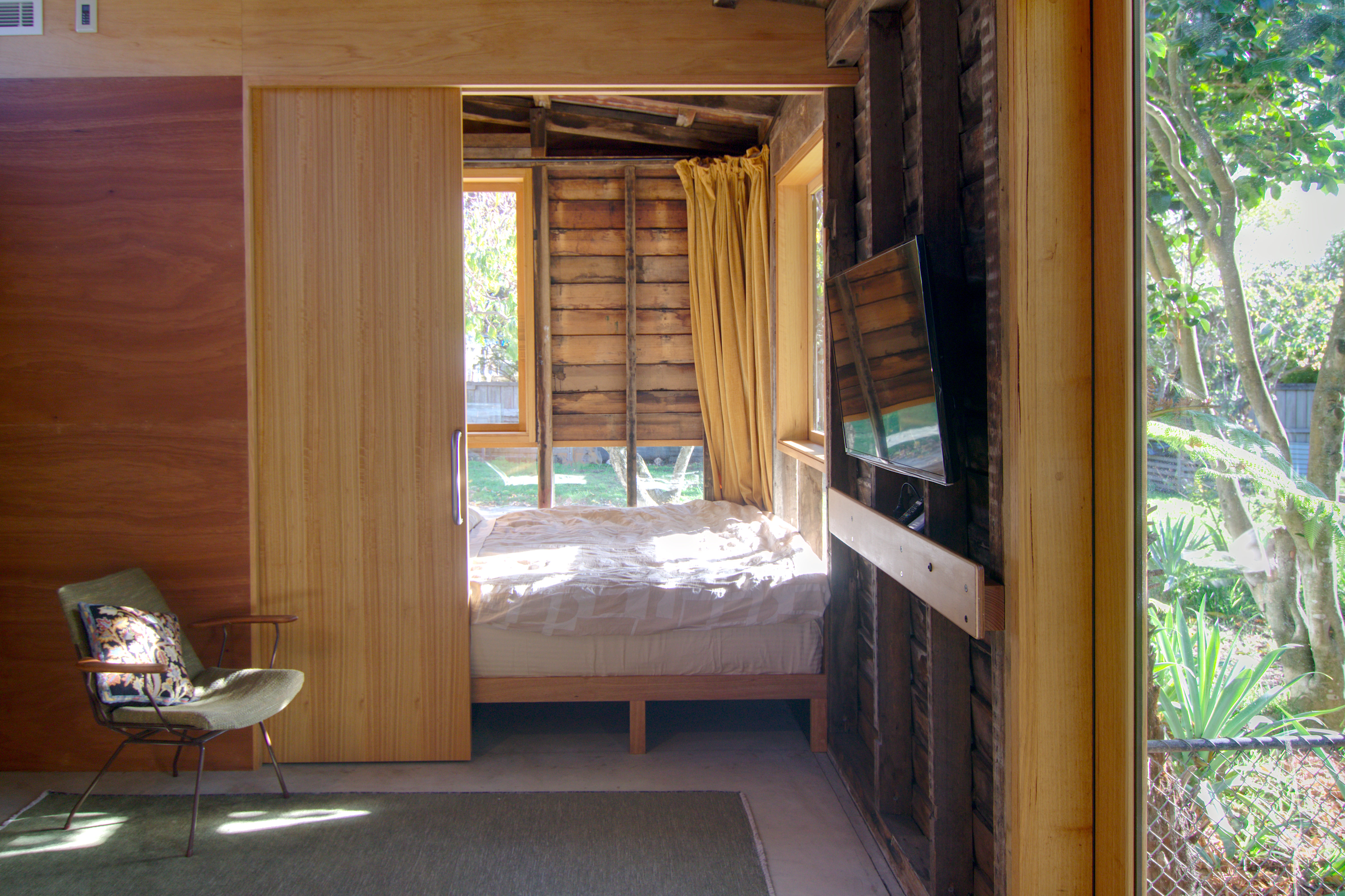 bedroom-alcove-door-partly-closed-curtains-open