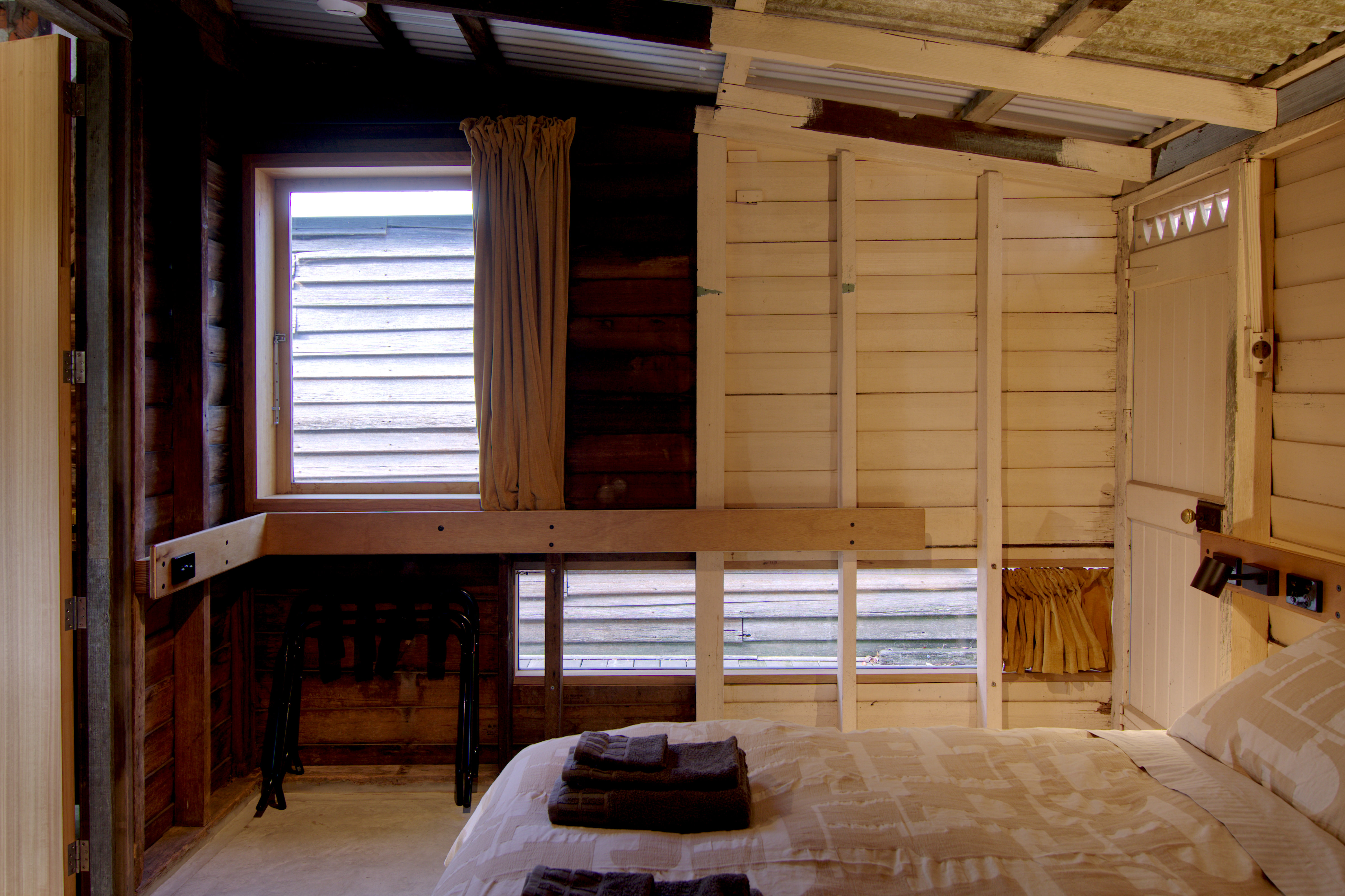 bedroom-main-curtains-open-luggage-rack-towels